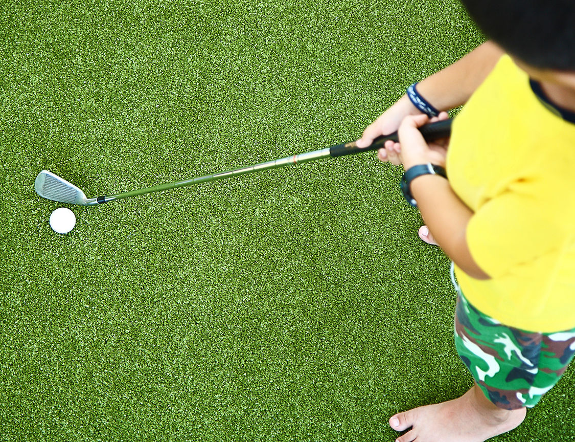 Small Kid Learning To Play Golf